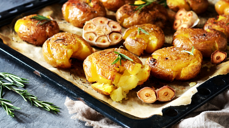 Smashed potatoes on a baking sheet