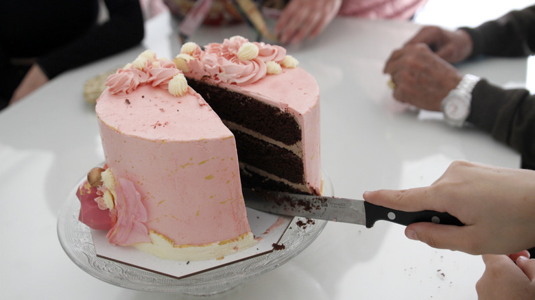 People cutting cake