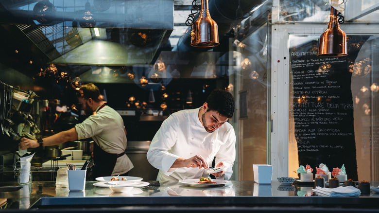 chefs preparing dishes at restaurant