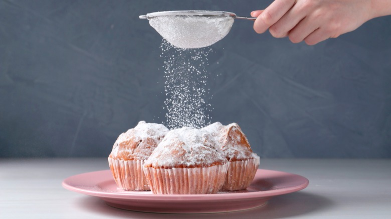 Powdered sugar sifted on muffins