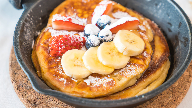 Banana pancakes in pan with other fruit