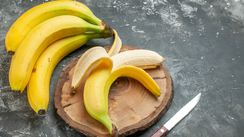 bunch of bananas, one peeled