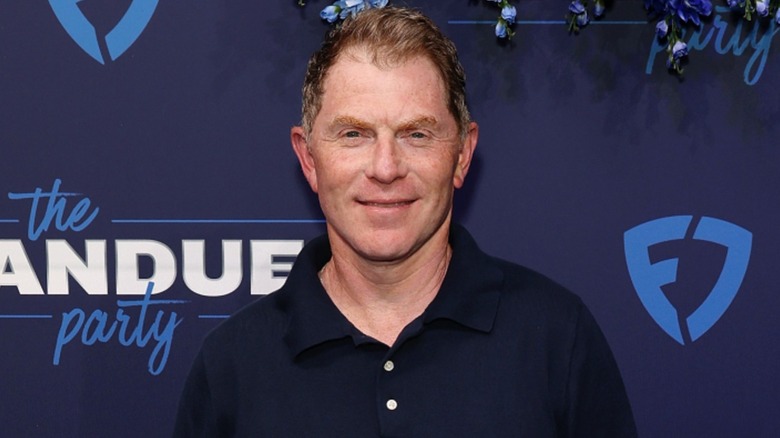 Bobby Flay smiling in dark blue polo