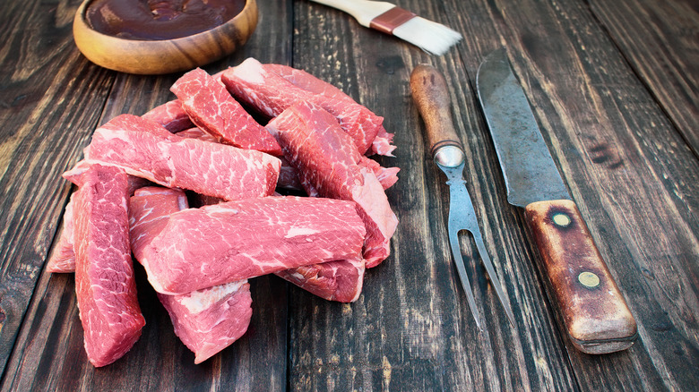 Raw boneless short ribs on a table.