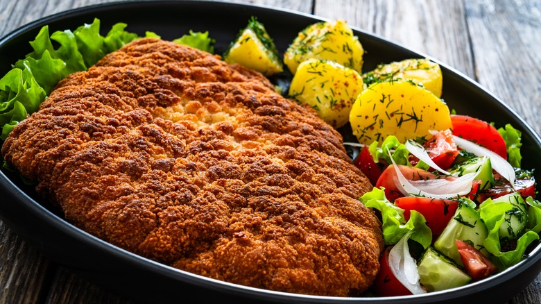 pork milanese with salad and potatoes