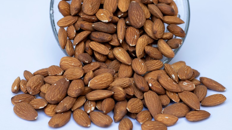 Almonds pouring out of bowl