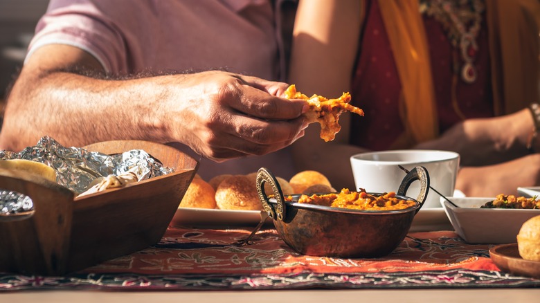 Person eating Indian food