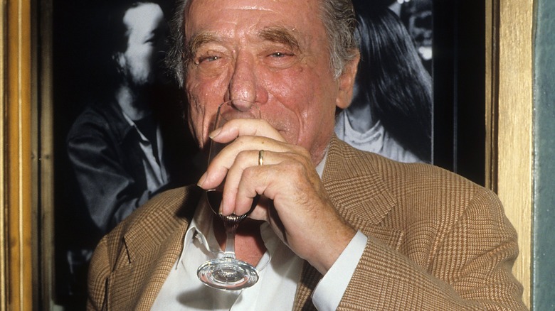 Charles Bukowski sipping drink