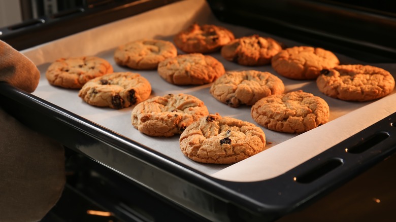 tray of chocolate chip cookies coming out of the oven