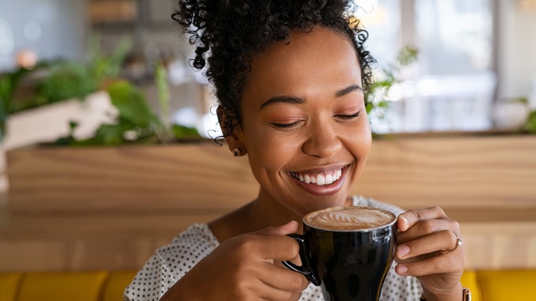 Person drinking a cup of coffee