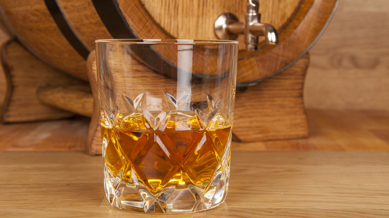 Mini whiskey barrel with glass of whiskey