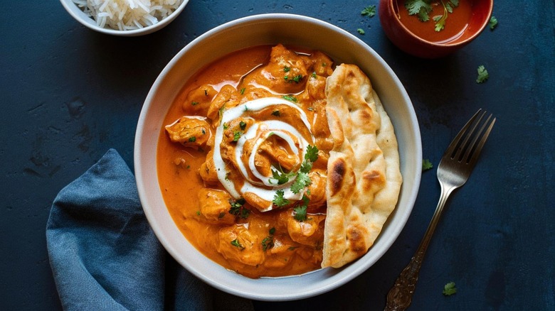 bowl of butter chicken and naan