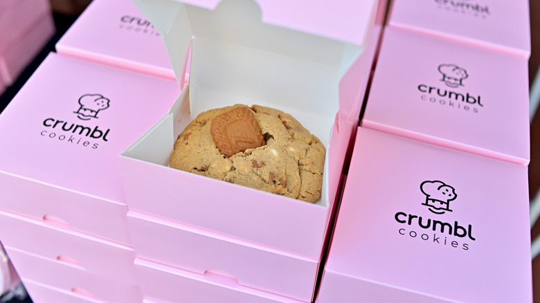 A stack of pink Crumbl boxes