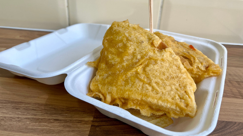 Deep fried pizza in a takeout box