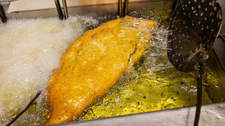 Neapolitan fried pizza cooking in oil