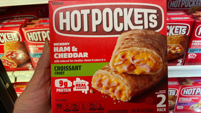 Hand holding package of Hot Pockets