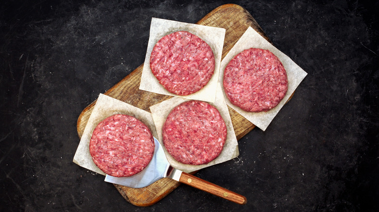 Hamburger patties on cutting board