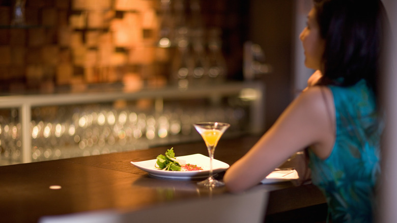 Person seated at a fancy bar