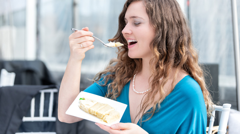 Woman eats wedding cake