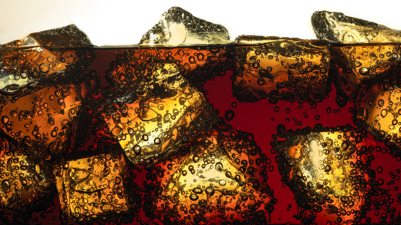 A bubbly glass of Coca-Cola on ice