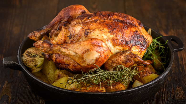 Roast chicken in a pot with potatoes