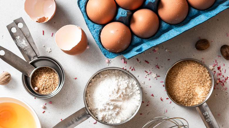 Eggs in a carton surrounded by other ingredients