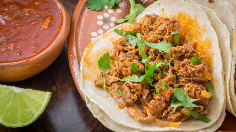 Imitation meat tacos with lime wedge and salsa