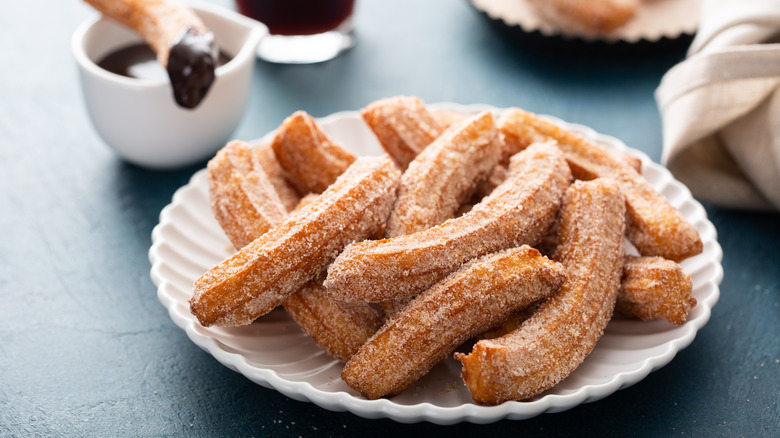 Fired churros with sugar and chocolate