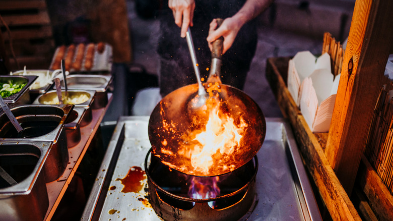 Cooking with a wok over traditional range