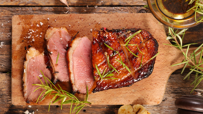 Roasted duck breast sliced on cutting board