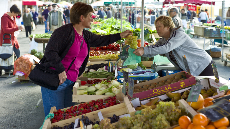 Woman buying grapes at farmer's market