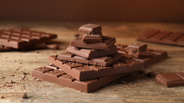 Stack of chocolate pieces on wood surface 