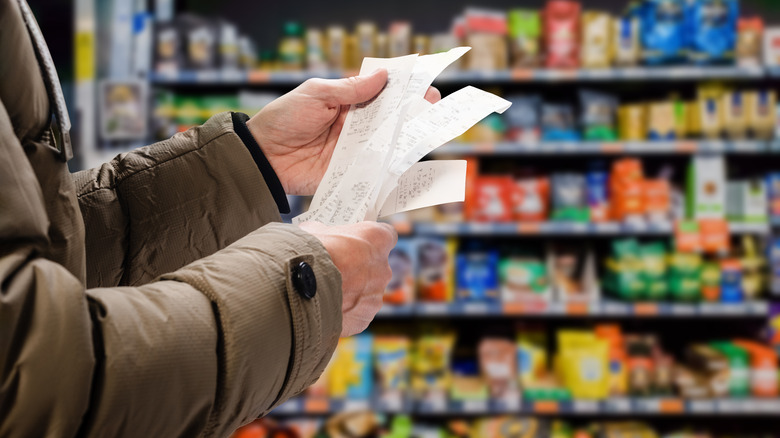 person inspecting receipts in store