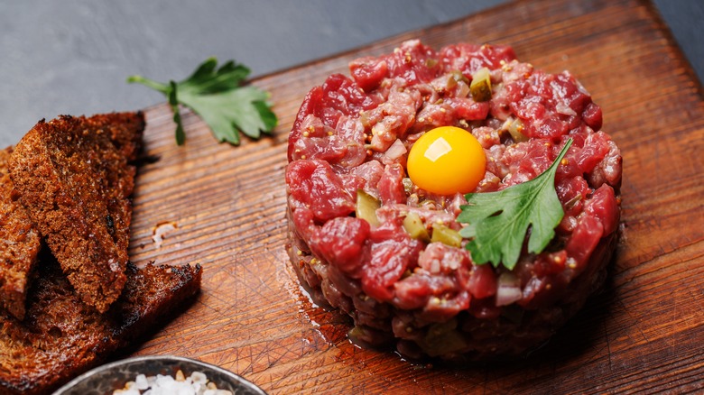 A steak tartare on a wooden board