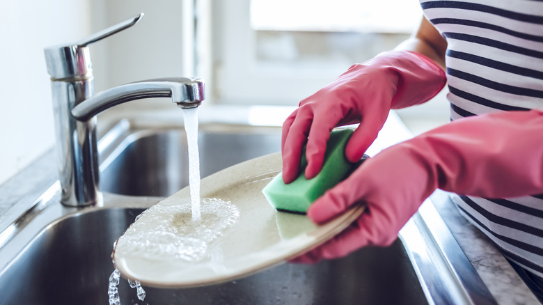 dish being cleaning in sink