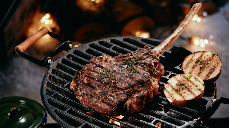 Tomahawk steak on a grill.