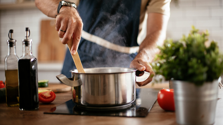 man stirring a pot 