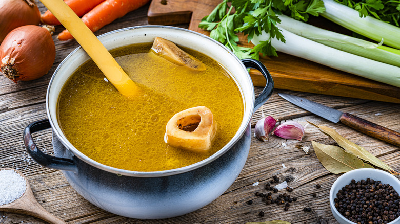 Bone broth in pot with vegetables