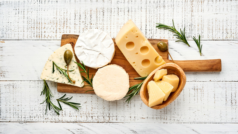 Variety of cheeses on a wooden board