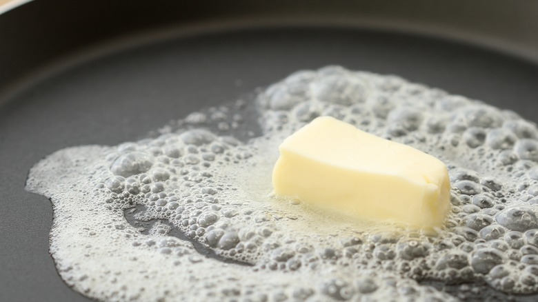 butter in hot frying pan