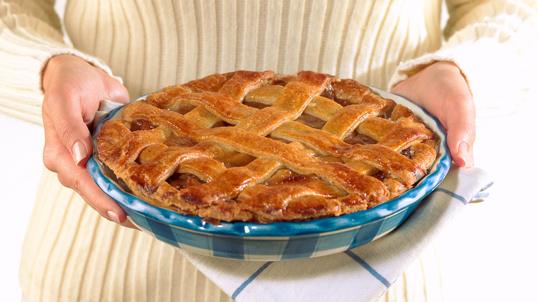 Woman holding apple pie