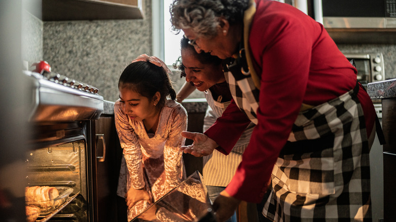 family looking into the oven