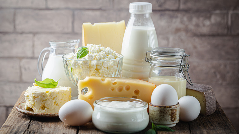 Eggs, milk, and cheese on a wood table