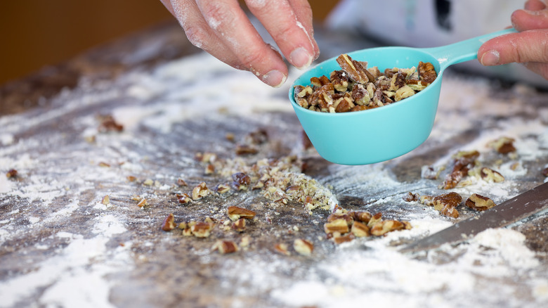 Chopped nuts in a measuring cup