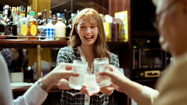 Young woman drinking at a bar