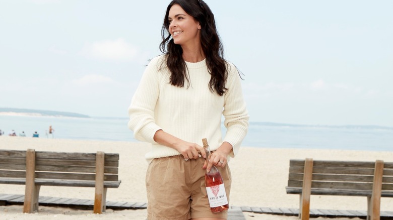 Katie Lee holding bottle of Kind of Wild wine