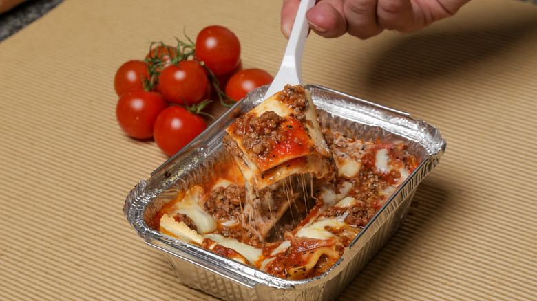 lasagna in container, side dish, fork