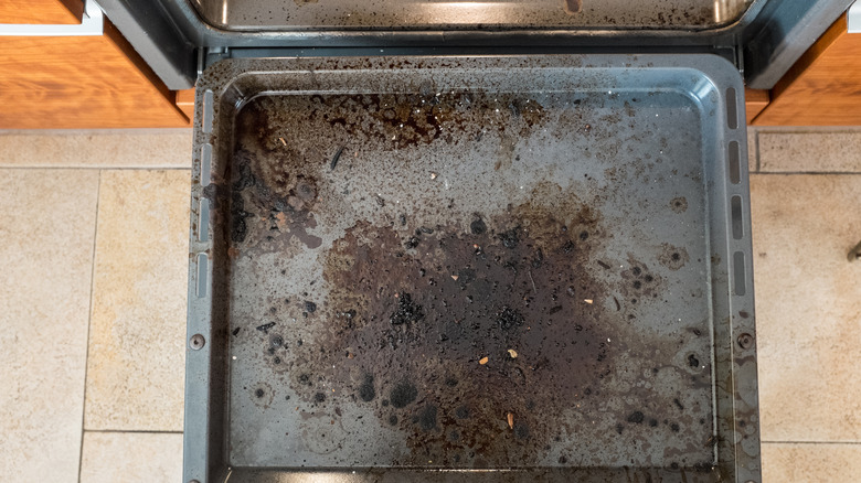 burned bits on bottom of oven