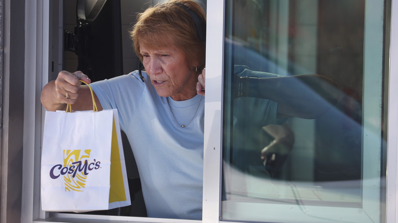 worker handing CosMc's ordering to customer