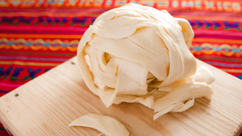 oaxaca cheese on cutting board